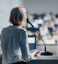 a woman speaking to a crowd