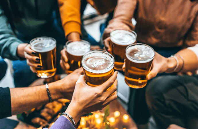 closeup of friends holding beers
