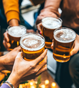 a group of friends holding beers